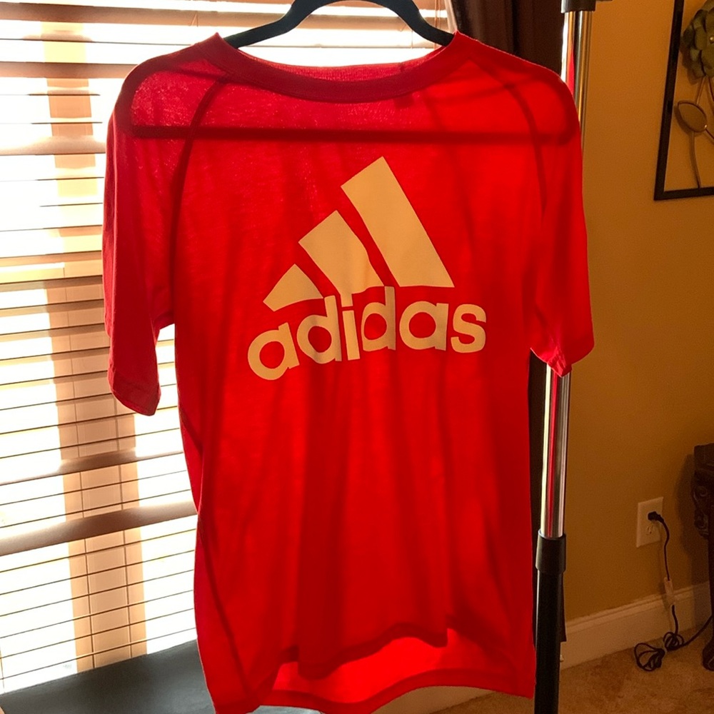 Red adidas shirt.
